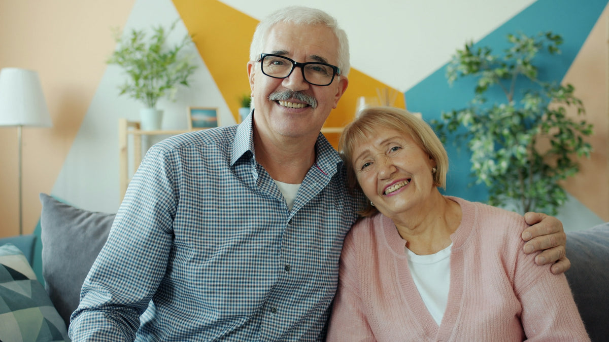 Smiling couple relaxing together on a couch at home